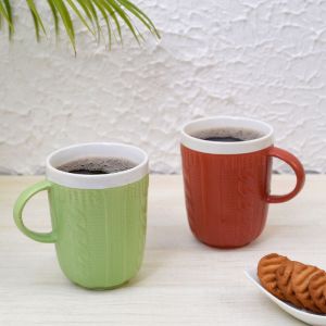 Unravel India Ceramic tableware serving hand knitted multicolor tea/coffee mug set(Set of 2)